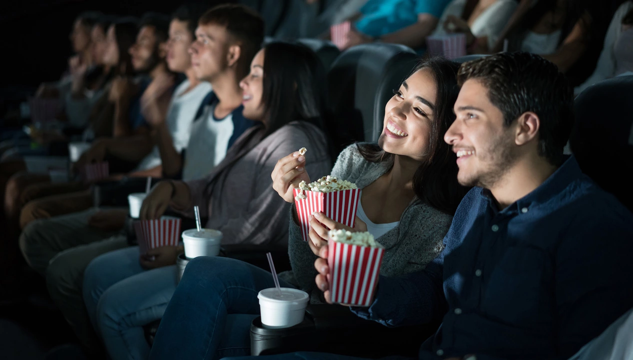Why do people go to the cinema to watch a film?